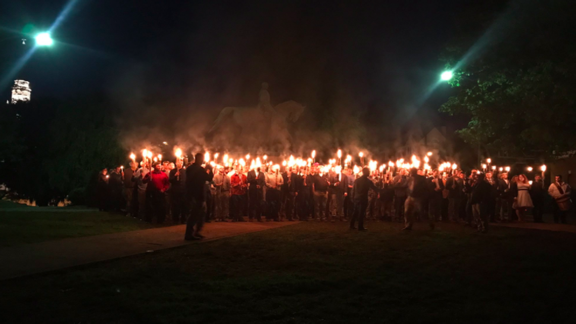 A crowd gathers near a statue of Confederate General Robert E. Lee to protest plans by city government to remove it in Charlottesville, Virginia.
