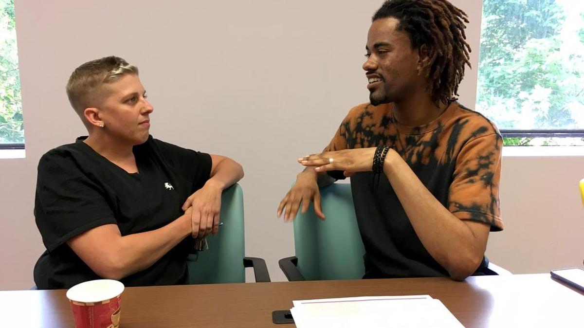 Jamie Longo, left, and Tarik Arafat, "recovery coaches" at Community Health Action of Staten Island in New York, discuss care for people dealing with drug addiction and alcoholism.