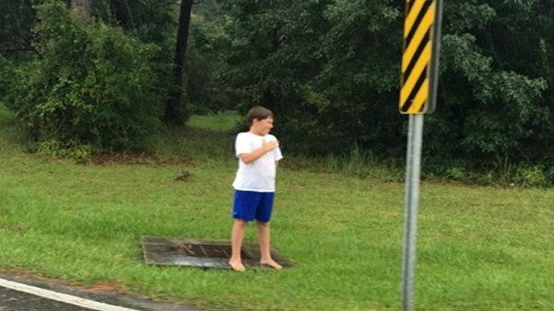 Kaiden Wade, 9, stood with his hand on his heart in the rain for 30 minutes Saturday during the funeral procession of World War II and hometown hero Jerry O’Keefe.