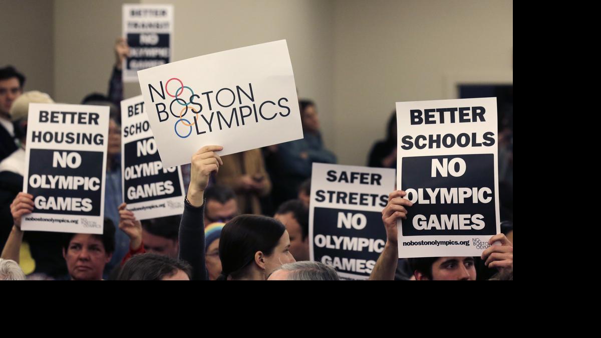 
People hold up placards against the Olympic Games coming to Boston on Feb. 5 during the first public forum regarding the city's 2024 Olympic bid, in Boston. The bid has been canceled, and the U.S. Olympic Committee is seeking a last-minute substitute, with Los Angeles, San Francisco and Washington being mentioned.
