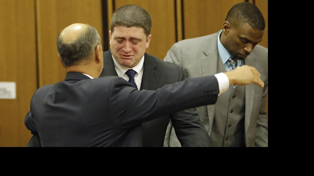 
Michael Brelo hugs his attorney, Patrick D’Angelo, after the verdict in his trial Saturday, May 23, 2015, in Cleveland. Brelo, a patrolman charged in the shooting deaths of two unarmed suspects during a 137-shot barrage of gunfire was acquitted Saturday in a case that helped prompt the U.S. Department of Justice determine the city police department had a history of using excessive force and violating civil rights
