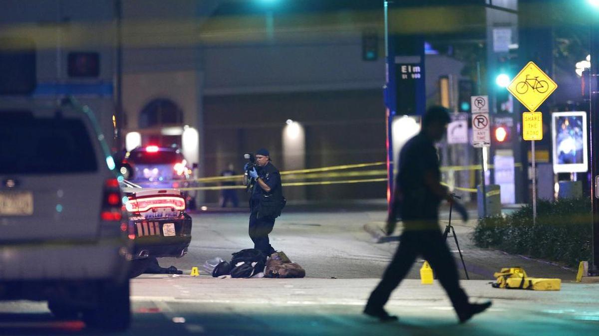 Police investigate the scene of Thursday’s fatal shooting, Friday, July 8, 2016, in Dallas. Snipers opened fire on police officers in the heart of Dallas Thursday night, during protests over two recent fatal police shootings of black men.