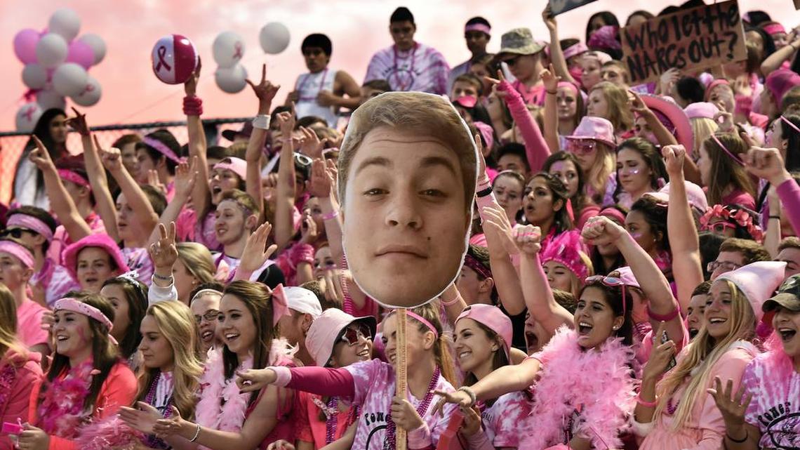 The sky goes pink behind the Broad Run High School student section for an Oct. 17 game against Briar Woods in Ashburn, Va.