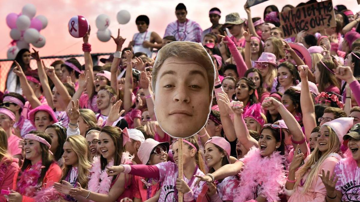 The sky goes pink behind the Broad Run High School student section for an Oct. 17 game against Briar Woods in Ashburn, Va.