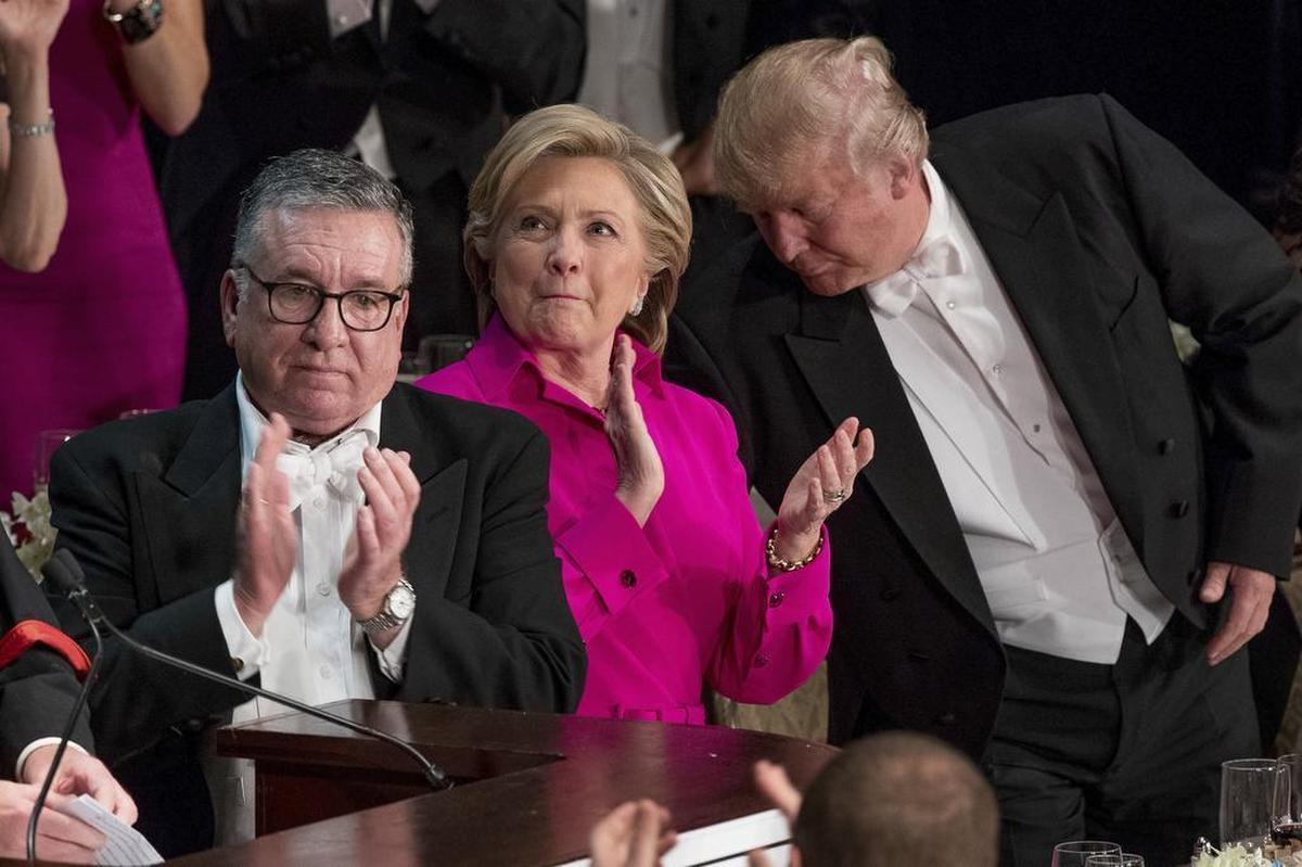 In this Oct. 20, 2016 file photo, from left, Alfred E. Smith IV, Democratic presidential candidate Hillary Clinton, and Republican presidential candidate Donald Trump stand to applaud during the 71st annual Alfred E. Smith Memorial Foundation Dinner in New York.