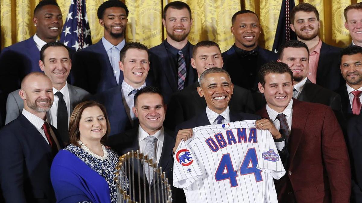 President Barack Obama holds up a personalized Chicago Cubs baseball jersey presented to him for a group photo during a ceremony in the East Room of the White House in Washington, Monday, Jan. 16, 2017, where the president honored the 2016 World Series Champion baseball team.
