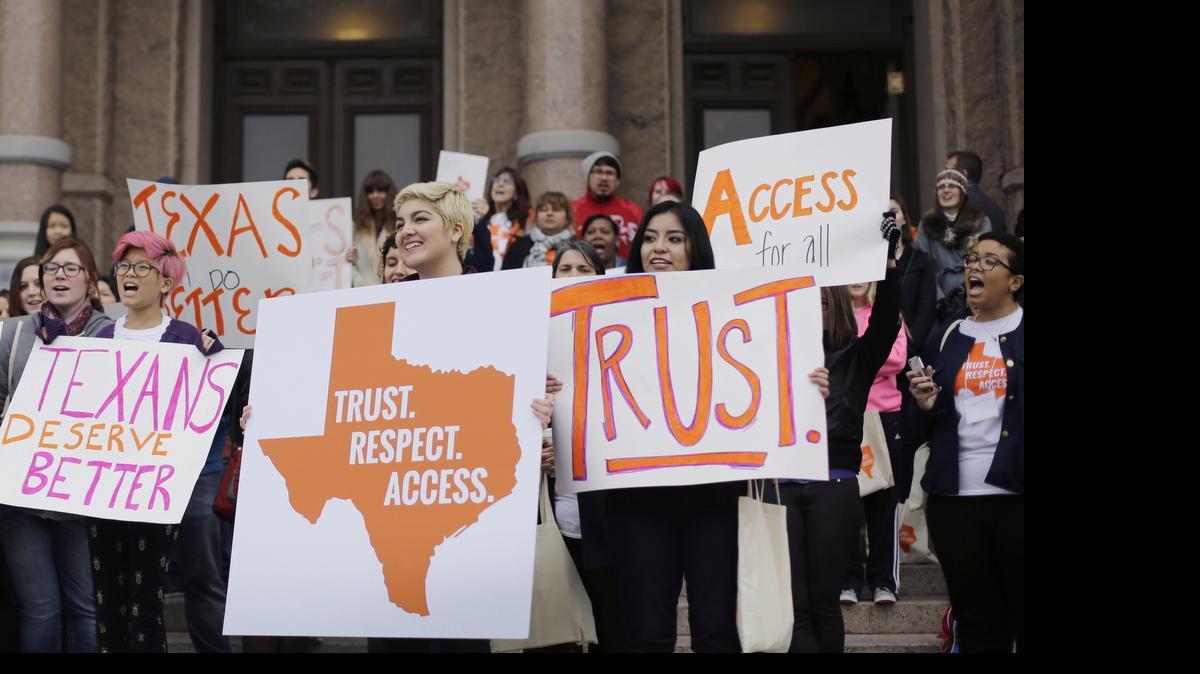 
College students and abortion rights activists hold signs during a rally on the steps of the Texas Capitol in Austin, Texas, on Feb. 26. The Supreme Court refused on Monday to allow Texas to enforce restrictions that would force 10 abortion clinics to close.
