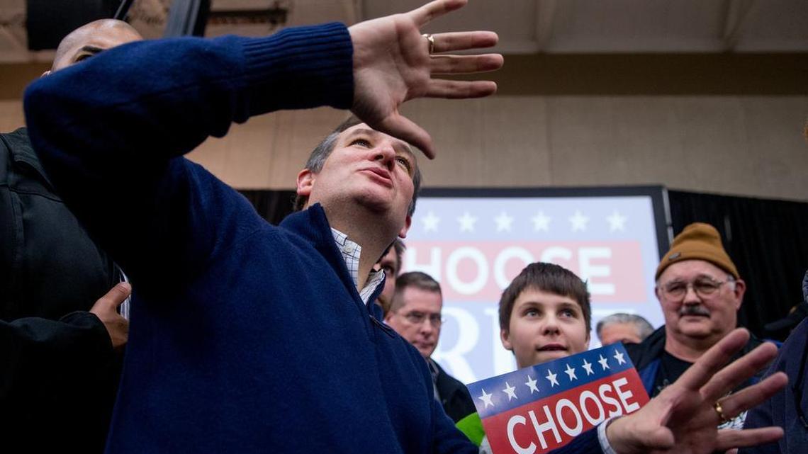 Republican presidential candidate Sen. Ted Cruz, R-Texas, jokingly reacts upon greeting a member of the audience standing on a chair above him after Cruz spoke at a rally at the Five Sullivan Brothers Convention Center in Waterloo, Iowa, Saturday, Jan. 23, 2016.