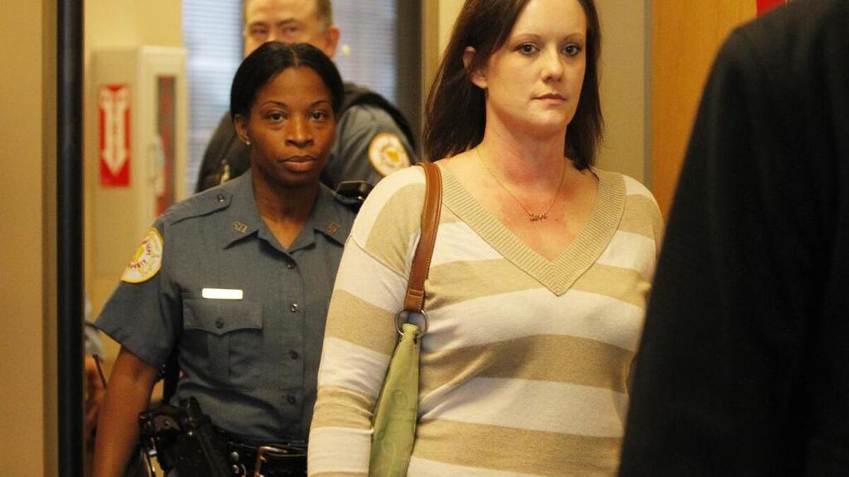 Alissa Jackson of Belleville leaves the courtroom at the St. Clair County Building on Thursday afternoon. For nearly two years, Jackson told people she was going to die from ovarian cancer, leaving her five children motherless. On Thursday, she admitted in court she never had cancer at all, but accepted the meals, money and a minivan from those who wanted to help her. Jackson, 32, pleaded guilty to two counts of theft of more than $500 by deception.