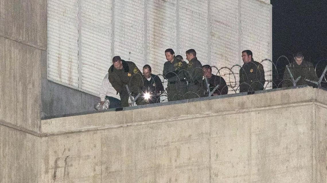 Orange County sheriff's deputies investigate early Jan. 23, 2016, after three jail inmates charged with violent crimes escaped from the Central Men's Jail in Santa Ana, Calif. All of the men are accused of violent crimes.