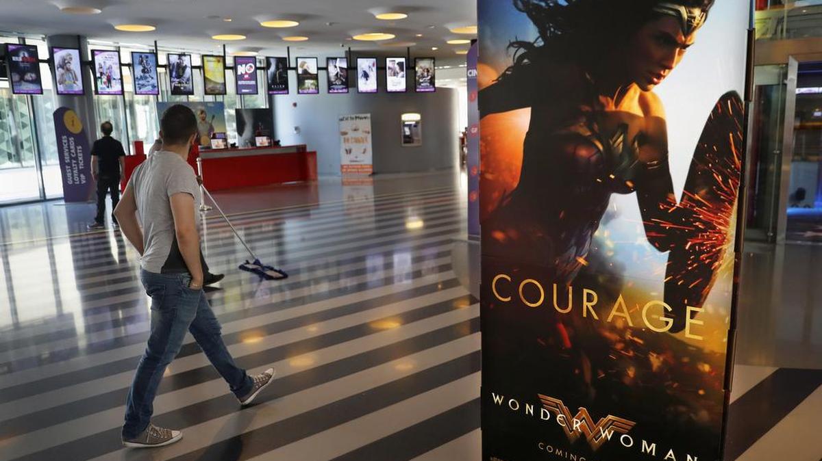 A man walks past a poster promoting the movie, Wonder Woman, at a cinema in downtown Beirut, Lebanon, Tuesday, May 30, 2017.
