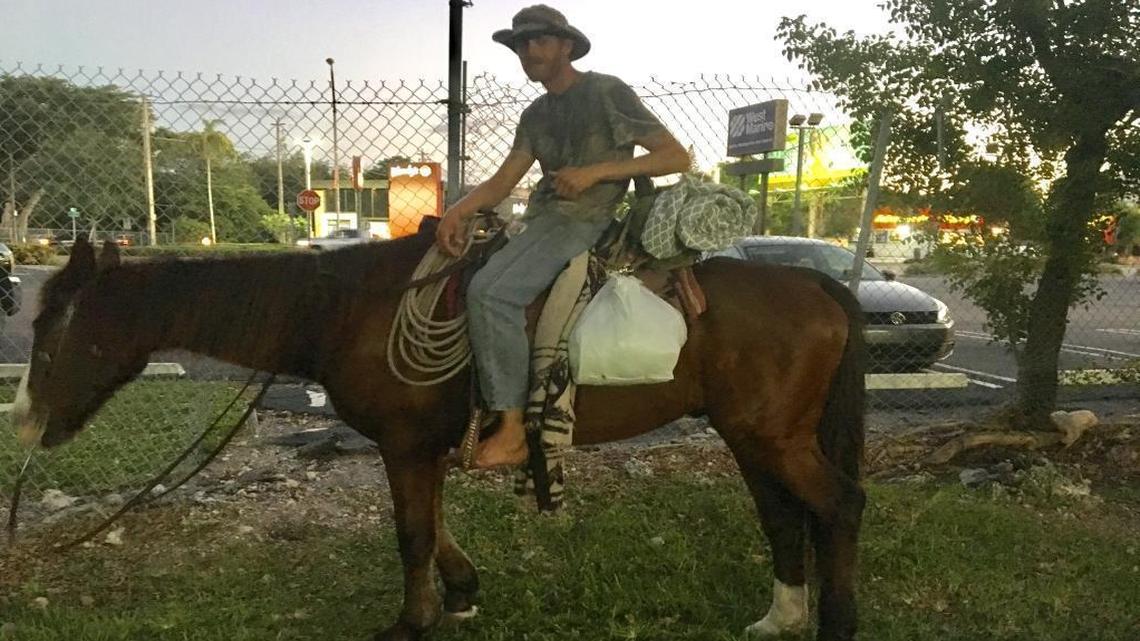 Chris Emerson on Trigger, a horse he said he rode from South Carolina to Miami. Photographed Tuesday night on a path under the Metrorail tracks near Coconut Grove, he was arrested Wednesday morning on animal-cruelty charges tied to Trigger’s health.