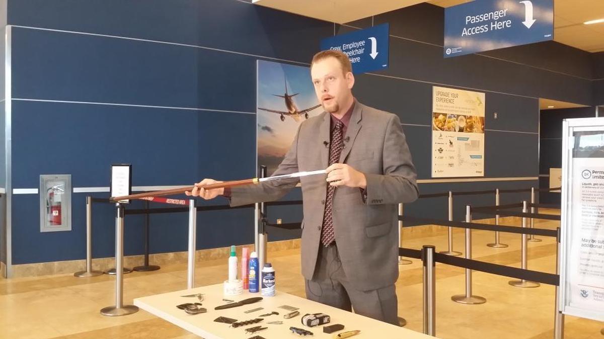 TSA official Mark Howell shows how a sword was almost carried onto a flight out of Myrtle Beach International Airport. It was hidden inside the cane.