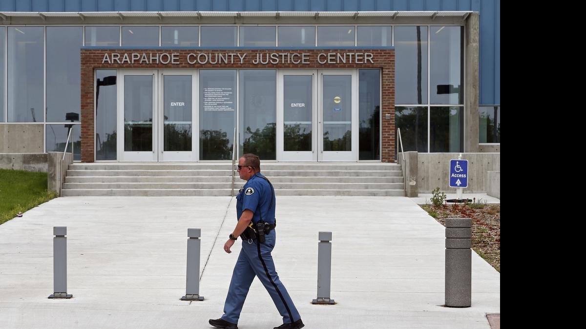 
A sheriff's deputy walks the grounds of the Arapahoe County District Court, where the trial of Aurora movie theater shooter, James Holmes, continues, Wednesday, July 8, 2015, in Centennial, Colo. Prosecutors are tearing into the testimony of a second defense expert who concluded the shooter was so mentally ill that he couldn't tell right from wrong when killed 12 people and injured 70 during a packed midnight movie premiere three years ago.
