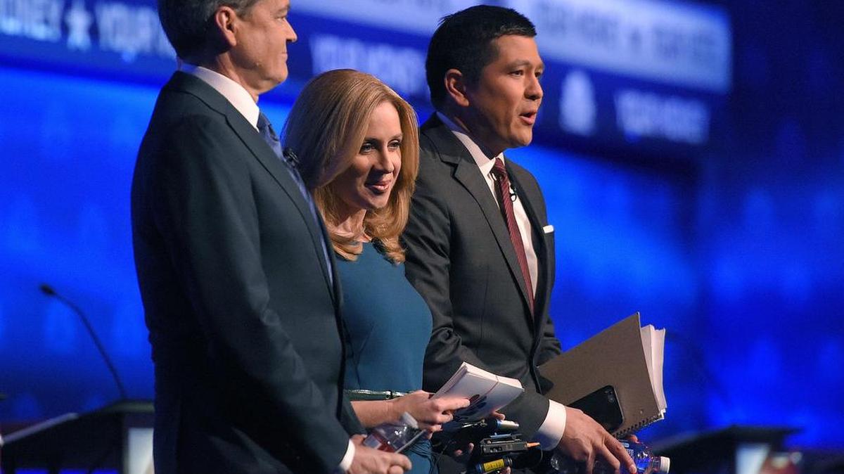 From left, debate moderators John Harwood, Becky Quick and Carl Quintanilla take the stage during the CNBC Republican presidential debate at the University of Colorado, Wednesday, Oct. 28, 2015, in Boulder, Colo.