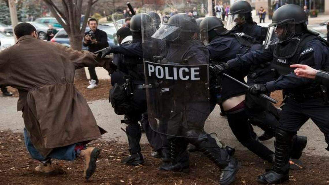 
After months of violence that ensued following the fatal shooting of Michael Brown, a $4.75 million federal grant will support the National Initiative for Building Community Trust and Justice, a program to “enhance procedural justice, reduce bias and support reconciliation,” according to officials who rolled out the program’s details Mar. 12, 2015. In this photo, police officers charge demonstrators protesting in the week following the grand jury’s decision not to indict Ferguson Police Officer Darren Wilson in the fatal shooting of Michael Brown, in downtown St. Louis, Mo., Nov. 30, 2014.
