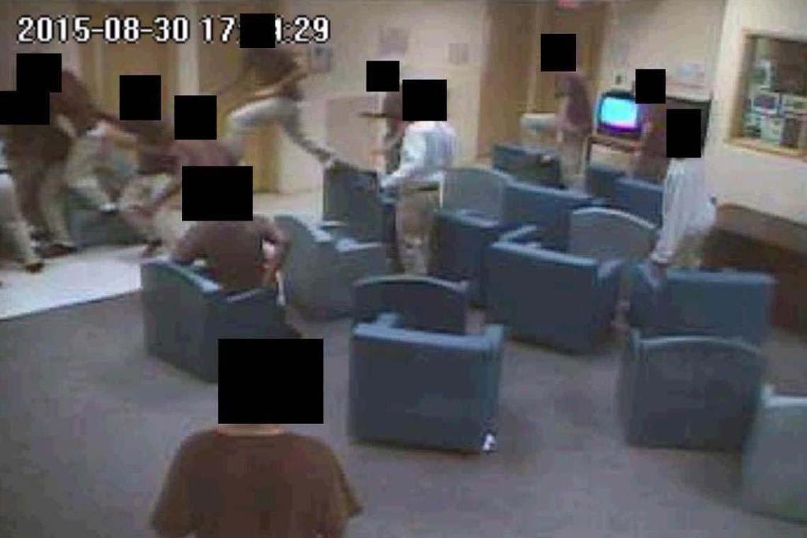 Detainees at the Miami juvenile lockup jump over chairs to get at Elord Revolte, who is in the upper left-hand portion of this video surveillance image, already engulfed.