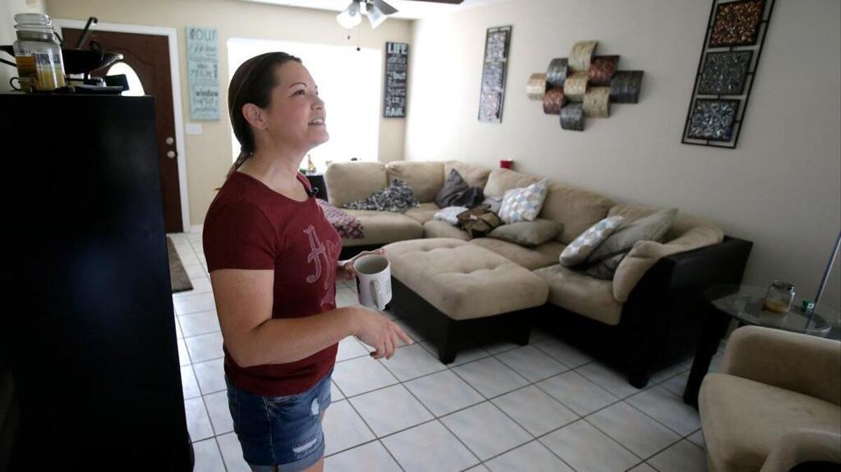 Renter Nicole Caverlyat gets settled at her home in the Piedmont Park neighborhood in Apopka, Fla., a former agricultural hub now crowded with housing developments. Where one in 10 homes was once a rental, now more than a third are. Caverlyat just moved into the neighborhood. Her home was purchased by an investment group in January and then put on the rental market.