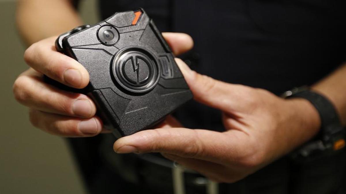 LAPD officer Jim Stover demonstrates a body camera. While more and more police departments are using the devices, there’s a lack of data as to what effect they may have on the police and the public.