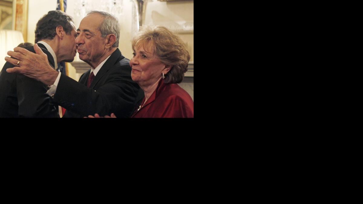 
In this Dec. 31, 2010, file photo, New York Gov. Andrew Cuomo, left, is congratulated by his parents, former Gov. Mario Cuomo, center, and mother, Matilda, during a private swearing-in ceremony at the Executive Mansion in Albany, N.Y. Mario Cuomo died Thursday, Jan. 1, 2015, the day his son started his second term as governor, the New York governor's office confirmed. He was 82.
