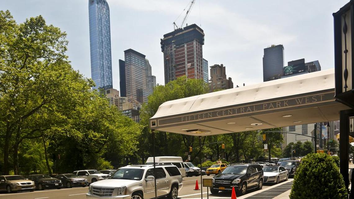 A luxury 90-floor apartment skyscraper called “One57,” left, rises above all other buildings overlooking Central Park, while a crane sits atop ongoing construction for a new condominium skyscraper at 220 Central Park South in New York. A penthouse in One57 went for $100.5 million in 2014, but an apartment in the new condominium tower is expected to sell for $250 million.