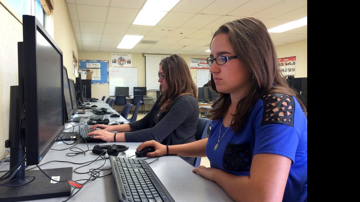
In this April 30, 2015 photo, Leticia Fonseca, 16, left, and her twin sister, Sylvia Fonseca, right, work in the computer lab at Cuyama Valley High School after taking the new Common Core-aligned standardized tests in New Cuyama, Calif. 
