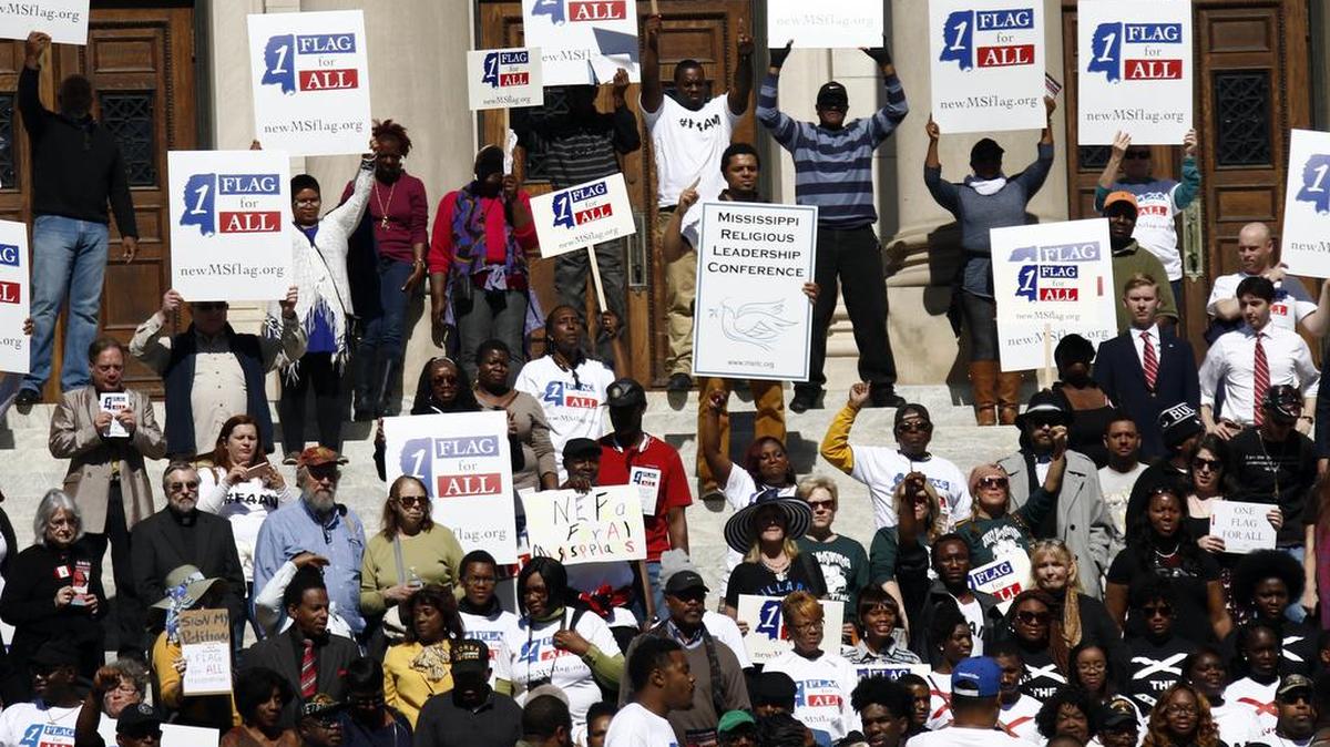 Several hundred people gather at the Mississippi State Capitol in Jackson for a rally to remove the Confederate battle emblem from the state flag on Thursday, a month after flag supporters gathered there for their own event.