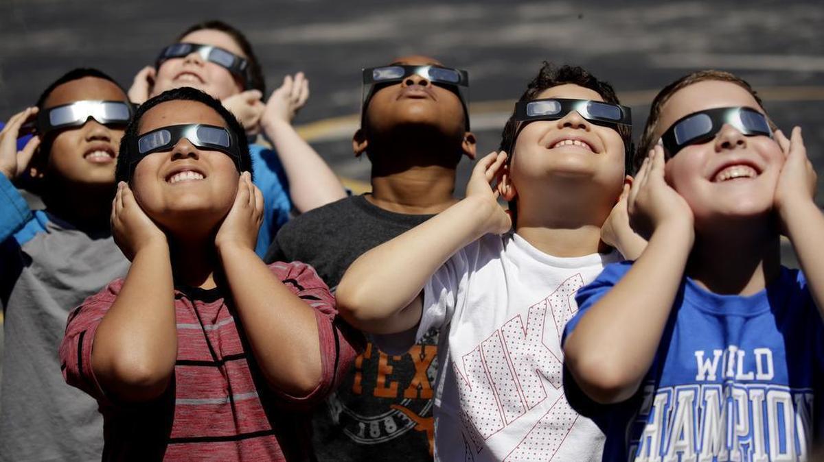 Fourth graders at Clardy Elementary School in Kansas City, Mo. practice the proper use of their eclipse glasses in 2017 in preparation for a solar eclipse. Schools around the country are preparing for the April 8 solar eclipse.