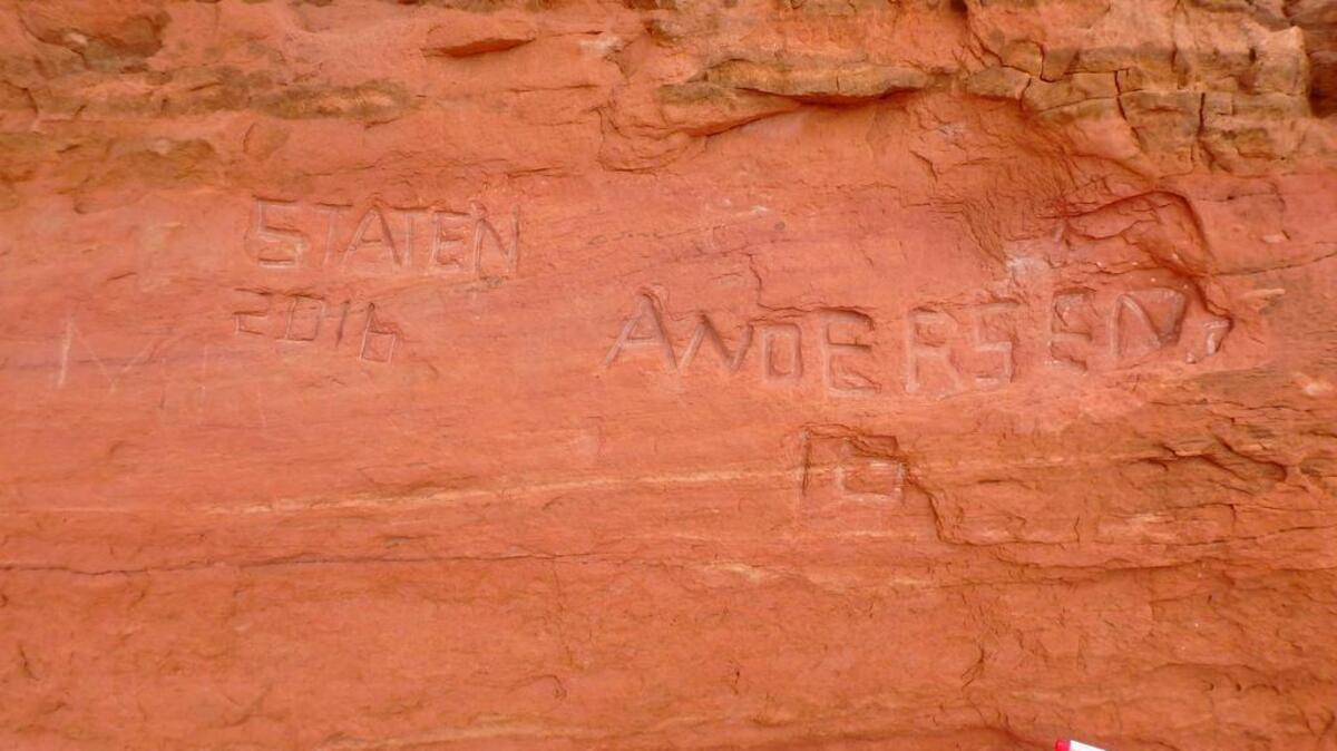Graffiti carved at Frame Arch in Arches National Park in Utah. Authorities say the words are so deeply carved into one of the park's famous red rock arches that it might be impossible to erase.