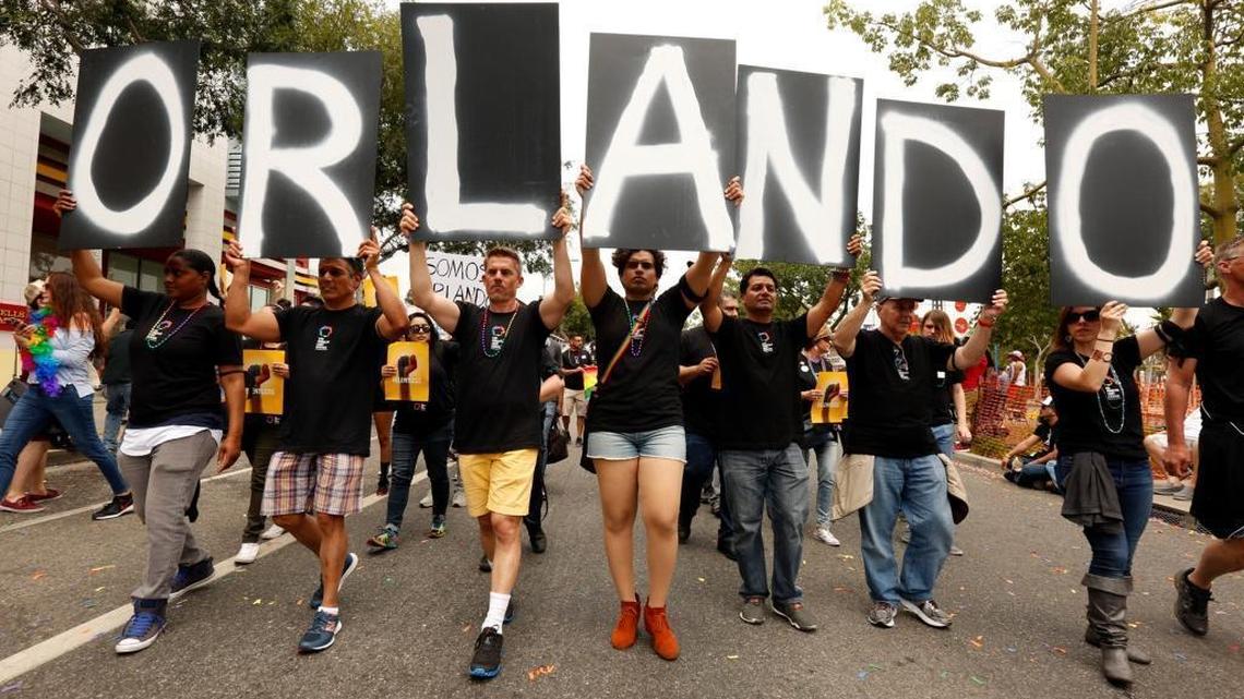 Marchers in the annual Gay Pride parade in West Hollywood spell out Orlando in support of the victims of Sunday's mass shooting.