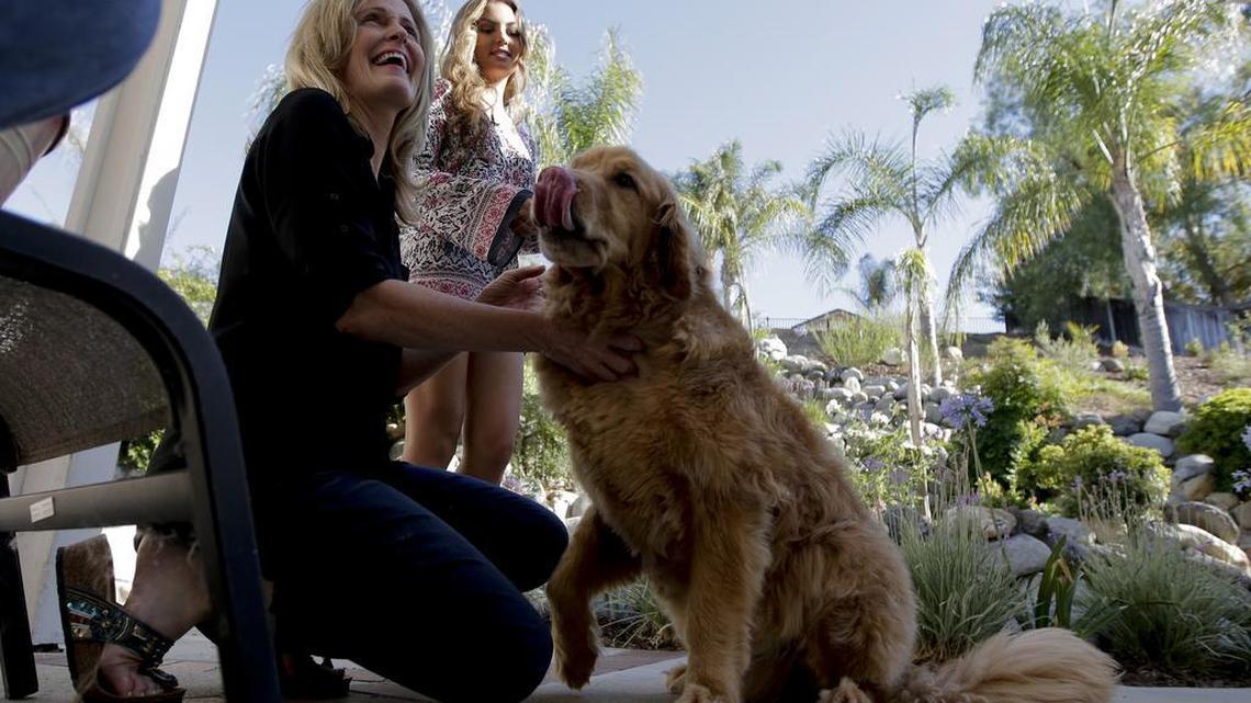 
Jill Rosales talks about student debt at her home in Temecula, California, on July 10, 2015. Her dog and daughter stand nearby. 

