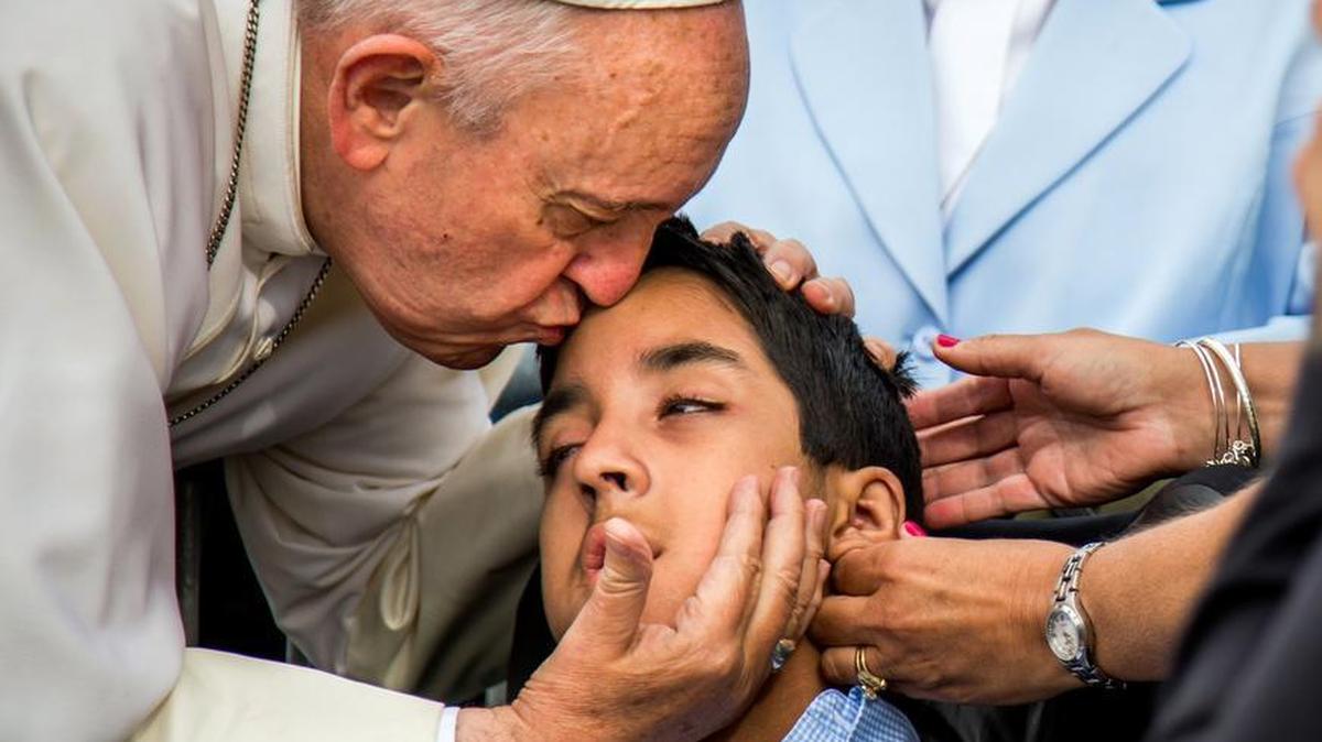 
 Pope Francis kisses and blesses Michael Keating, 10, of Elverson, Pa., after arriving in Philadelphia and exiting his car when he saw the boy on Saturday, Sept. 26, 2015, at Philadelphia International Airport. Keating has cerebral palsy and is the son of Chuck Keating, director of the Bishop Shanahan High School band that performed at Pope Francis’ airport arrival. 
