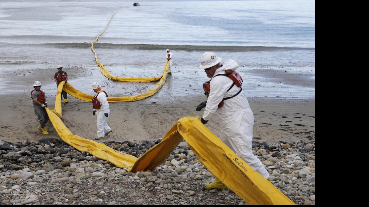 
Workers prepare an oil containment boom at Refugio State Beach, north of Goleta, Calif., Thursday, May 21, 2015. More than 7,700 gallons of oil has been raked, skimmed and vacuumed from a spill that stretched across about 9 miles of California coast, just a fraction of the sticky, stinking goo that escaped from a broken pipeline, officials said. 
