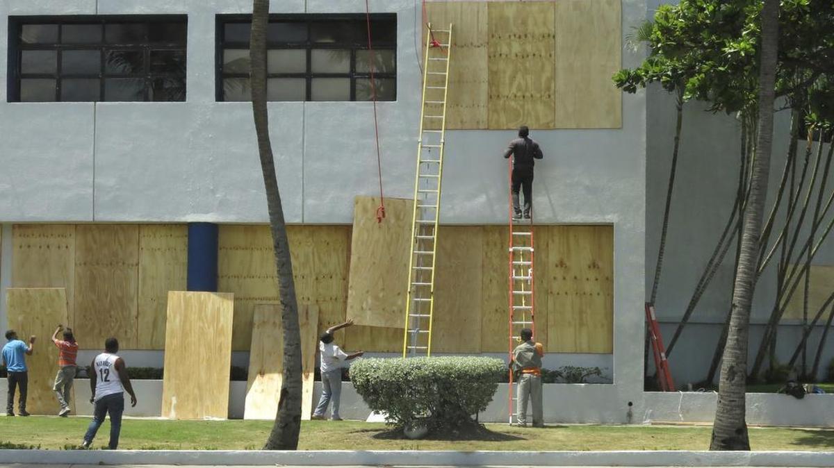 Employees of the Dominican Immigration Office board up the windows of their building as they prepare for the arrival of Hurricane Irma, in Santo Domingo, Dominican Republic, Wednesday, Sept. 6 2017. The strongest hurricane ever measured in the Caribbean is expected to lash the Dominican Republic with heavy rains and 185-mph winds batting other islands in the region.