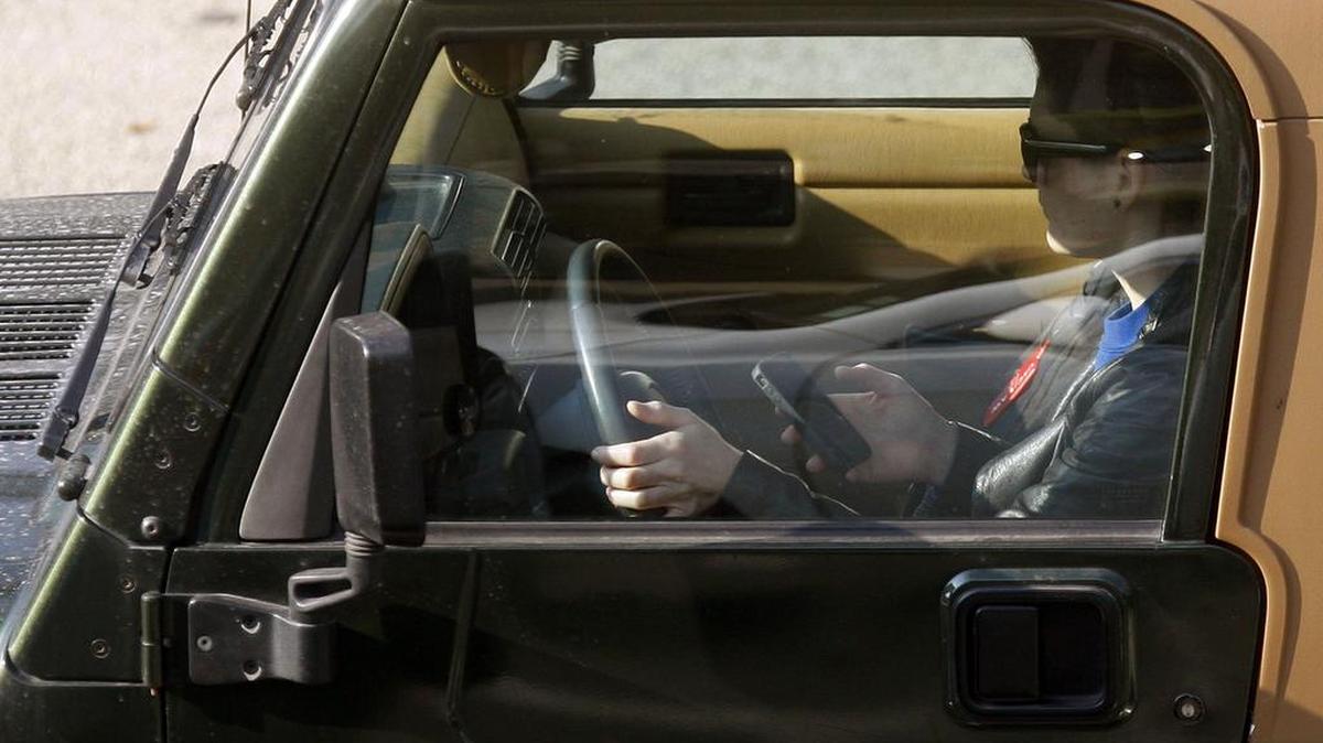 A driver uses an iPhone while driving in Los Angeles in 2011.