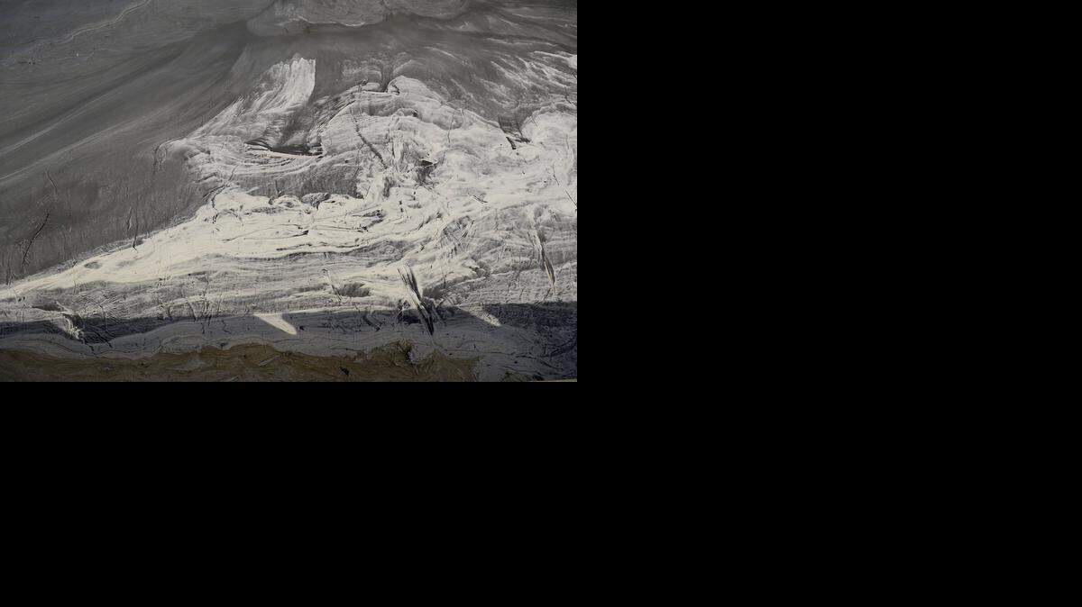 
Swirls of coal ash accumulates in eddies and waters appear gray in the Dan River in Danville, Va. down stream from the Dan River Steam Station in Eden, NC, in 2014. 
