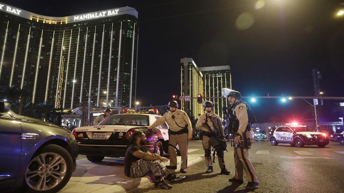 Police officers stand at the scene of a shooting near the Mandalay Bay Resort and Casino on the Las Vegas Strip on Sunday that claimed more than 50 people. The shooter, Stephen Paddock, lived and worked in North Texas in recent years.