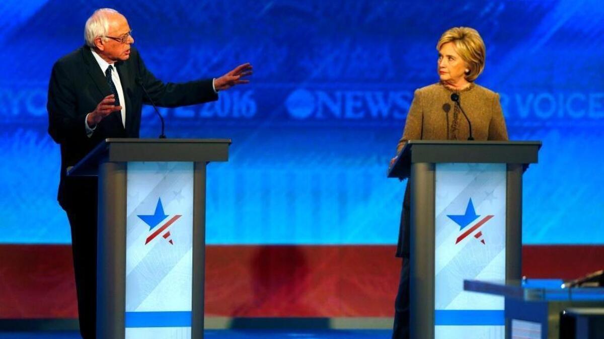 Bernie Sanders, left, offers an apology to Hillary Clinton during a Democratic presidential primary debate Saturday, Dec. 19, 2015, at Saint Anselm College in Manchester, N.H.