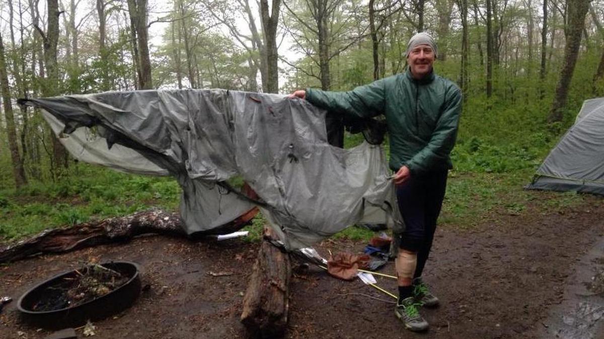 Hiker Bradley Veeder poses with what was left of his tent after a bear attacked. ‘If it looks odd to see me smiling, I felt such a warm feeling of gratitude to be alive that I couldn’t possibly have frowned,’ he said.