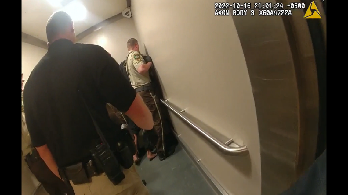 Jail staff holding up Nickolas Daniel Norberg in an elevator.