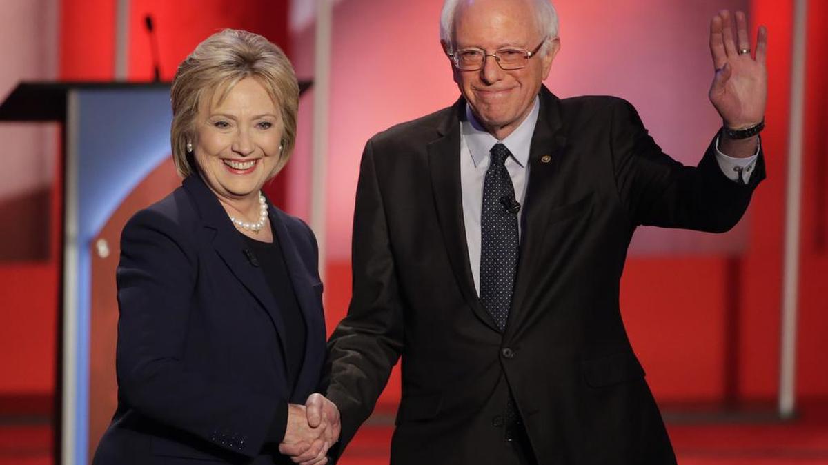 Hillary Clinton and Sen. Bernie Sanders shake hands as they greet the audience before a Democratic presidential primary debate hosted by MSNBC at the University of New Hampshire on Thursday, Feb. 4, 2016, in Durham.