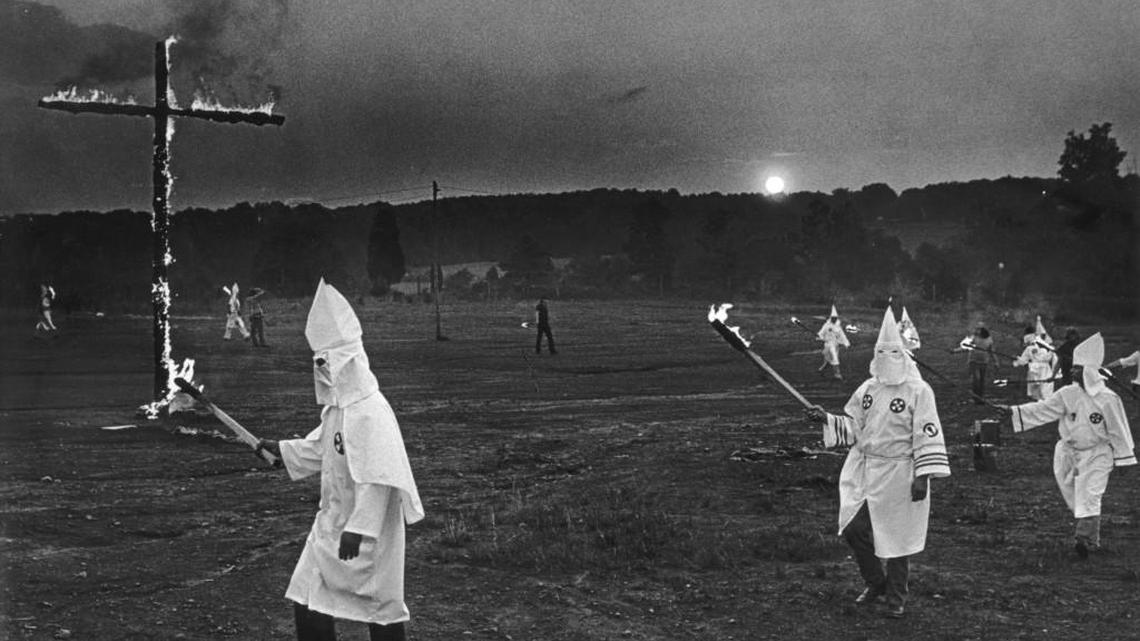 Ku Klux Klansmen circle a flaming cross at a KKK rally near Lincolnton, N.C. in late 1979 shortly after a Greensboro shootout between members of the KKK and American Nazi Party and members of the Communist Workers' Party. Four members of the CWP and one other person were killed and 10 people were wounded. At least two of the Klansmen charged in the shooting attended this rally.