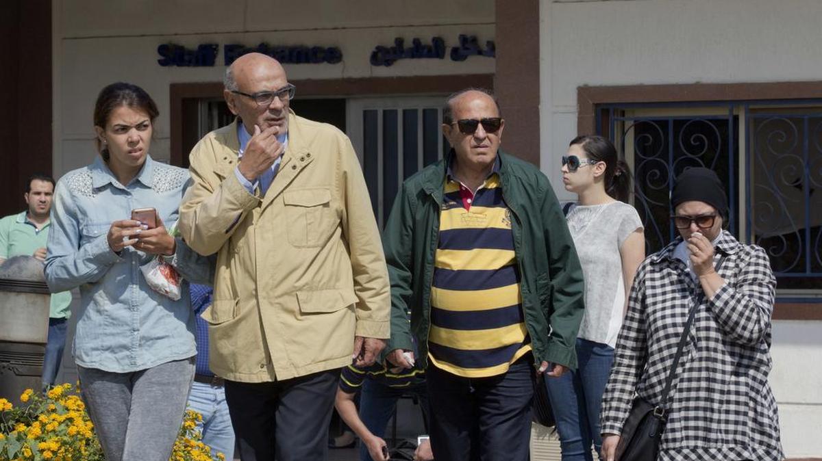 Relatives of passengers on a vanished EgyptAir flight leave the Egyptair in-flight service building where they were held at Cairo International Airport, Egypt.