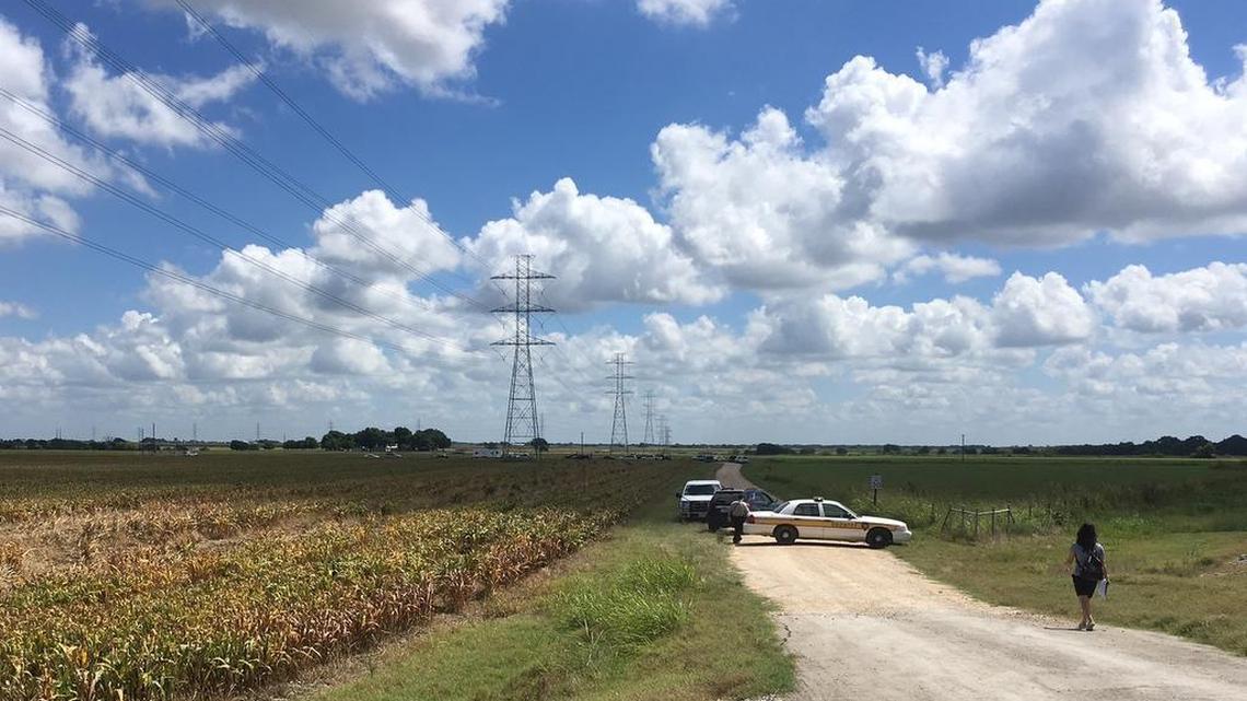 Police cars block access to the site where a hot air balloon crashed early Saturday, July 30, 2016, near Lockhart, Texas.