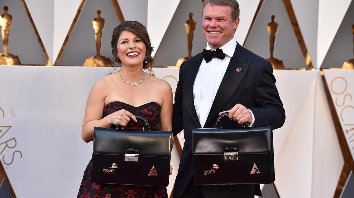 Martha Ruiz, left, and Brian Cullinan of PricewaterhouseCoopers, carry the envelops of the winners at the Oscars on Sunday, Feb. 28, 2016, at the Dolby Theatre in Los Angeles.
