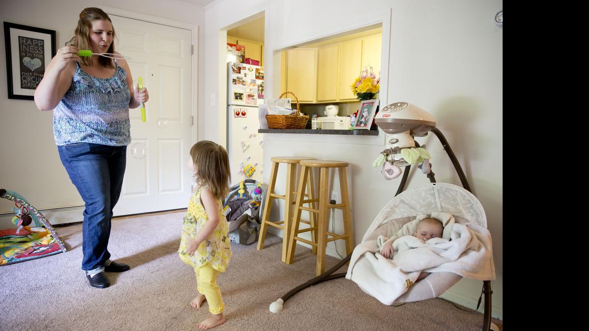 
Rachel Palencik plays with her daughter Claire, 2, as her son Trevor, 3 months, sleeps, June 17 in West Chester, Pa. About 4,000 mothers participate in 15 nonprofit milk banks across the United States, but the entry of for-profit milk banks has led to tensions as state lawmakers begin regulating the industry. Palencik wants to be sure that her breast milk goes to a mom and infant who need it.
