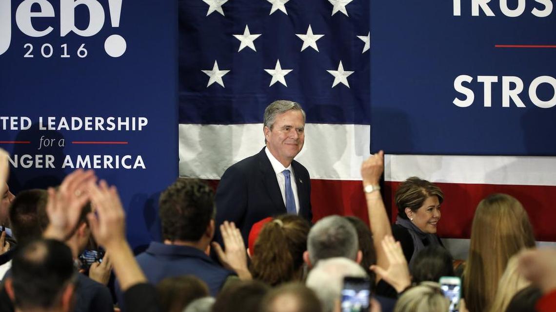 Former Florida Gov. Jeb Bush accompanied by his wife, Columba, moves to the stage at his South Carolina Republican presidential primary rally in Columbia, S.C., on Saturday, Feb. 20, 2016. New campaign finance reports show that Bush had limited funds left before he ended his campaign Saturday night.