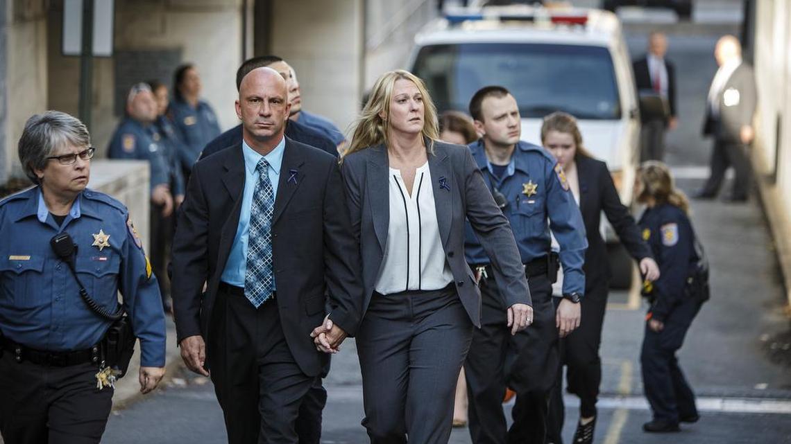 Lisa Mearkle, center, holding the hand of her husband, Jay, leaves the Dauphin County Courthouse after she was acquitted Nov. 5, 2015, at her murder trial in Harrisburg, Pa. A jury found the Hummelstown police officer not guilty on all charges on the third day of her murder trial. Mearkle was charged with third-degree murder, voluntary manslaughter and involuntary manslaughter for the fatal February shooting of 59-year-old David Kassick.