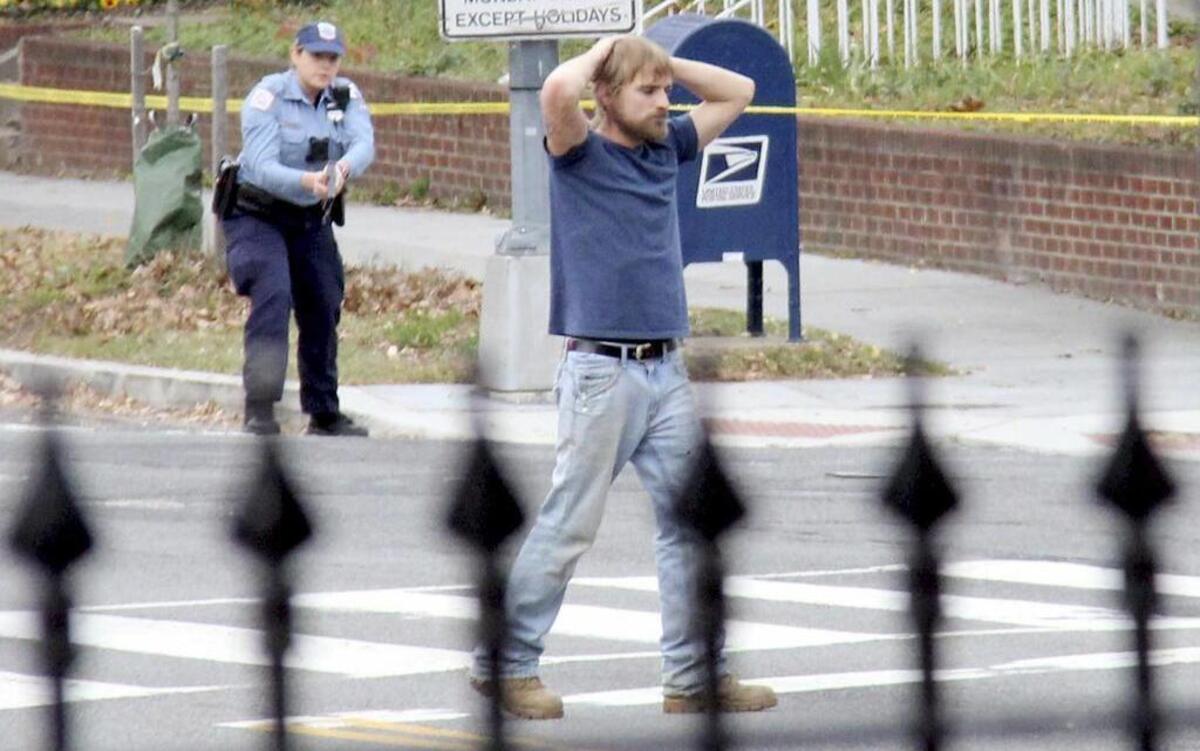 Edgar Maddison Welch, 28 of Salisbury, N.C., surrenders to police Sunday, Dec. 4, 2016, in Washington. Welch, who said he was investigating a conspiracy theory about Hillary Clinton running a child sex ring out of a pizza place, fired an assault rifle inside the restaurant on Sunday injuring no one, police and news reports said.