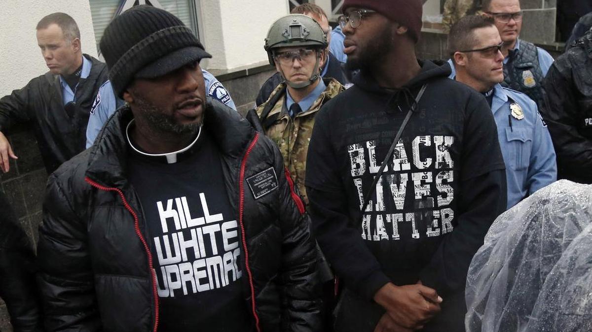 Minneapolis police guard the entrance to the Fourth Precinct as Black Lives Matter supporters continue their protest, Wednesday, Nov. 18, 2015, in Minneapolis.